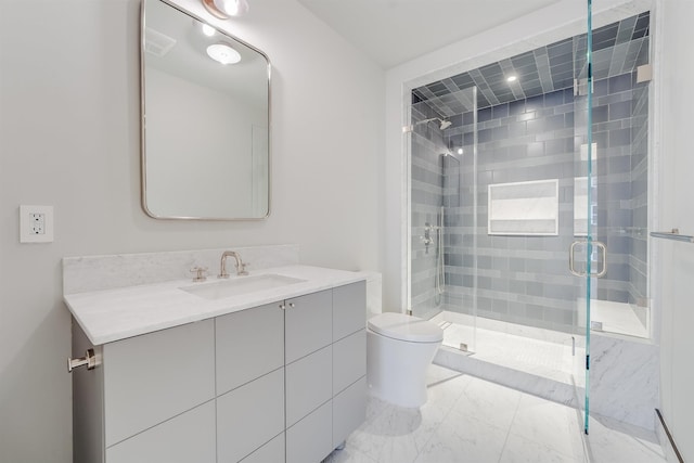bathroom with a shower stall, vanity, marble finish floor, and toilet