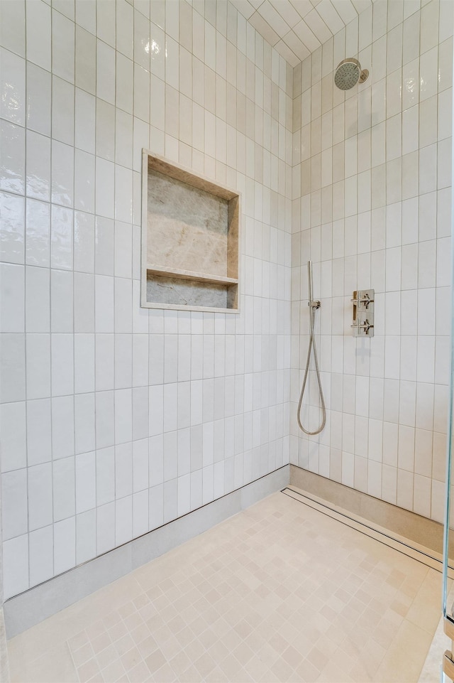 bathroom with tiled shower