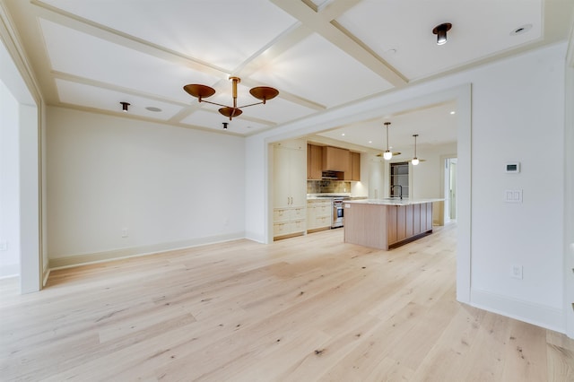 unfurnished living room with baseboards, a sink, a chandelier, light wood-style floors, and recessed lighting