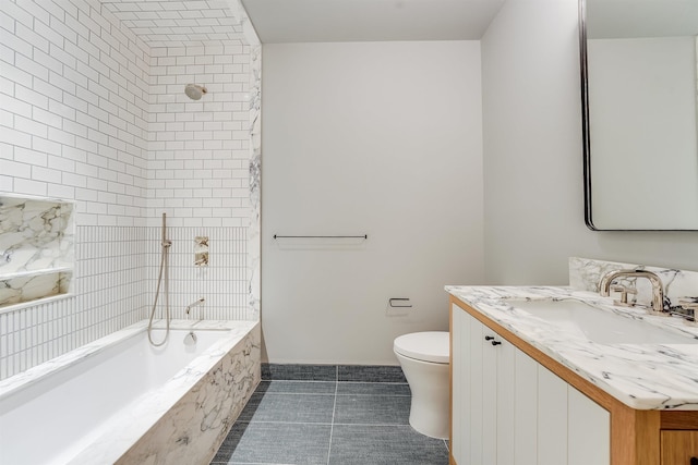 full bath featuring vanity, a tub with marble appearance, tile patterned floors, toilet, and tiled shower