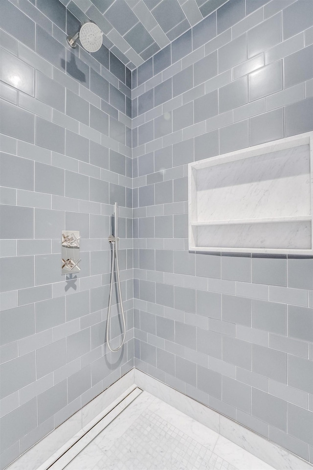 bathroom with tiled shower