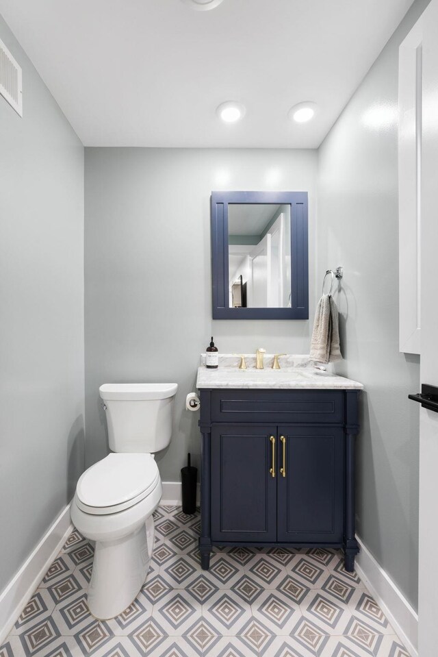 23 Manhattan Ave Unit 1, Jersey City, NJ 07307 - half bathroom featuring baseboards, vanity, and toilet