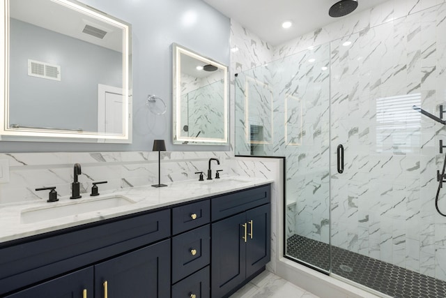 23 Manhattan Ave Unit 1, Jersey City, NJ 07307 - full bath with marble look tile flooring, a marble finish shower, and double vanity