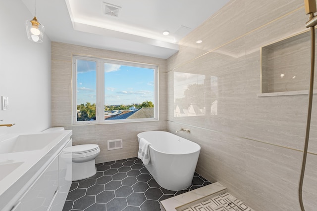 312 Garfield Ave Unit 2, Jersey City, NJ 07305 - full bathroom with tile walls, a freestanding bath, tile patterned flooring, and double vanity