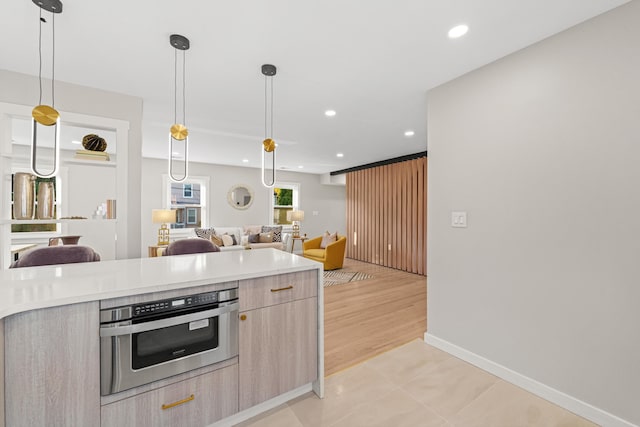 312 Garfield Ave Unit 2, Jersey City, NJ 07305 - kitchen with open floor plan, modern cabinets, light countertops, light brown cabinetry, and recessed lighting
