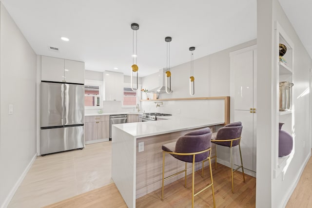312 Garfield Ave Unit 2, Jersey City, NJ 07305 - kitchen with stainless steel appliances, modern cabinets, extractor fan, a peninsula, and a kitchen bar