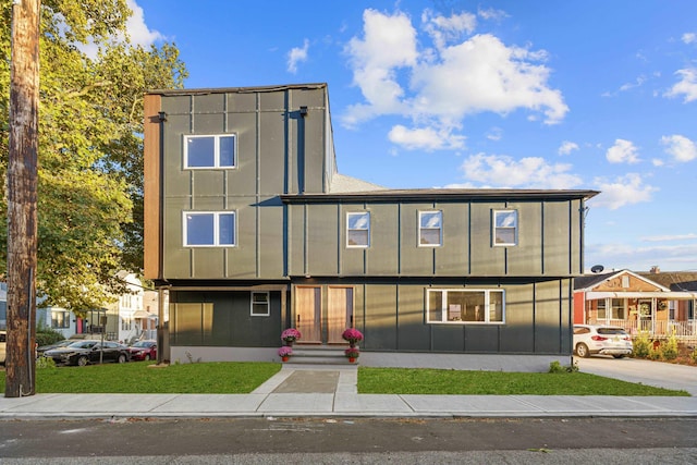 312 Garfield Ave Unit 2, Jersey City, NJ 07305 - view of front facade with board and batten siding and a front yard
