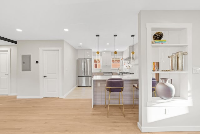 312 Garfield Ave Unit 2, Jersey City, NJ 07305 - kitchen with stainless steel fridge, light wood finished floors, a breakfast bar, light countertops, and recessed lighting