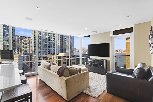 20 Newport Pkwy Unit 1108, Jersey City, NJ 07310 - living room with dark wood finished floors, recessed lighting, and a wall of windows