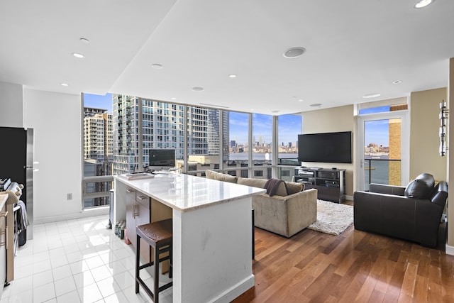20 Newport Pkwy Unit 1108, Jersey City, NJ 07310 - kitchen featuring recessed lighting, light stone counters, open floor plan, and baseboards