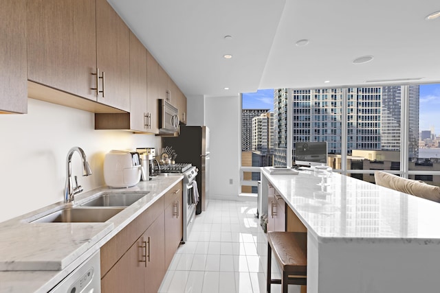 20 Newport Pkwy Unit 1108, Jersey City, NJ 07310 - kitchen with light stone counters, a spacious island, light tile patterned floors, appliances with stainless steel finishes, and a sink
