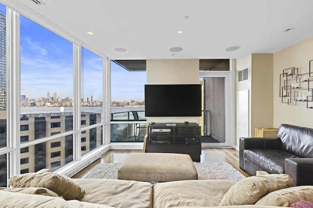 20 Newport Pkwy Unit 1108, Jersey City, NJ 07310 - living area featuring visible vents, a wall of windows, and light wood-style floors