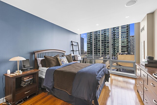 20 Newport Pkwy Unit 1108, Jersey City, NJ 07310 - bedroom featuring a view of city, wood finished floors, expansive windows, and visible vents