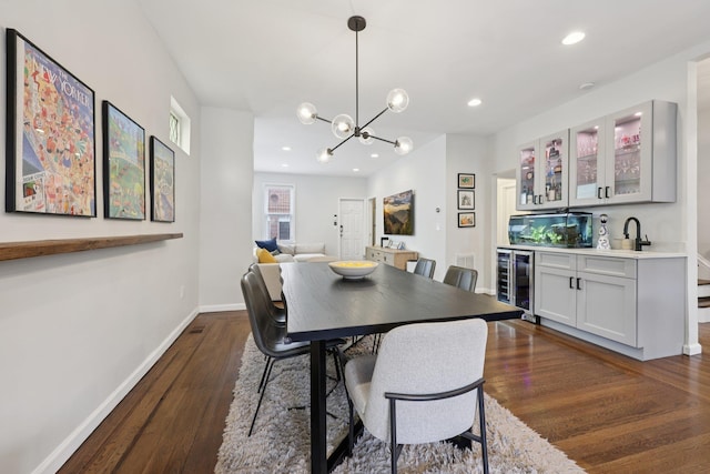 7619 5th Ave, North Bergen, NJ 07047 - dining room with wine cooler, bar with sink, dark wood-style floors, a chandelier, and recessed lighting