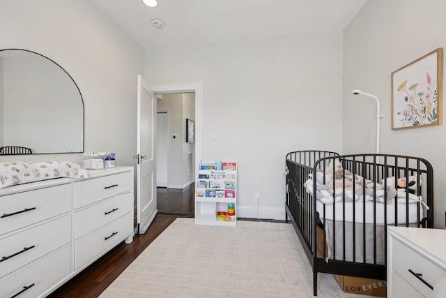 7619 5th Ave, North Bergen, NJ 07047 - bedroom with a crib, dark wood finished floors, and recessed lighting