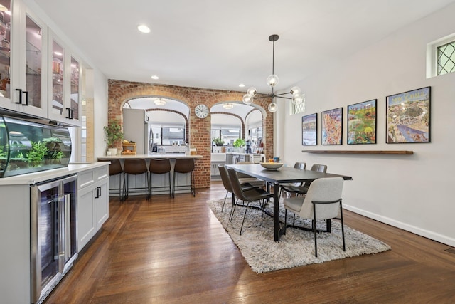 7619 5th Ave, North Bergen, NJ 07047 - dining area with beverage cooler, brick wall, dark wood-style flooring, a chandelier, and recessed lighting