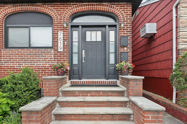 7619 5th Ave, North Bergen, NJ 07047 - doorway to property with brick siding and an AC wall unit