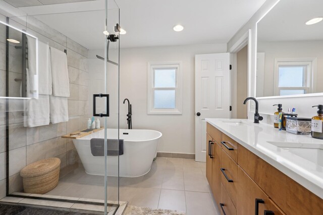 7619 5th Ave, North Bergen, NJ 07047 - full bathroom featuring double vanity, a stall shower, a freestanding bath, tile patterned flooring, and recessed lighting
