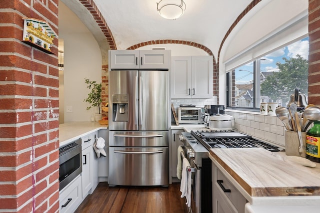 7619 5th Ave, North Bergen, NJ 07047 - kitchen with stainless steel appliances, backsplash, dark wood finished floors, and white cabinetry