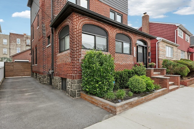 7619 5th Ave, North Bergen, NJ 07047 - view of property exterior with brick siding, an outbuilding, and a chimney