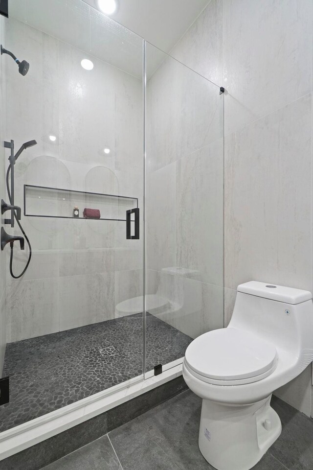 81 Webster Ave Unit 1, Jersey City, NJ 07307 - bathroom with a shower stall, tile walls, and tile patterned flooring