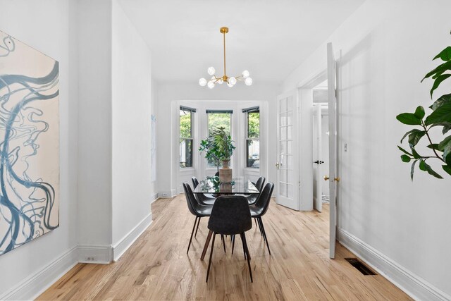 48 Armstrong Ave, Jersey City, NJ 07305 - dining space with a chandelier and light wood-style flooring