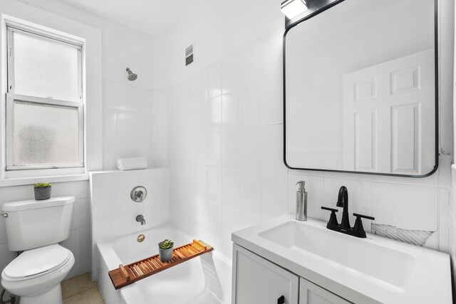 48 Armstrong Ave, Jersey City, NJ 07305 - bathroom featuring tile walls, vanity, shower / bathtub combination, and decorative backsplash