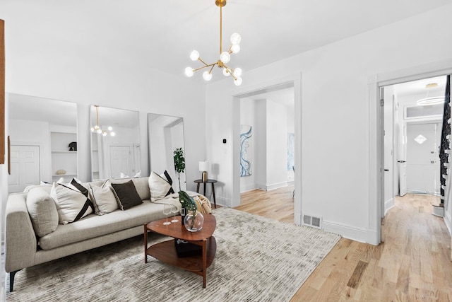 48 Armstrong Ave, Jersey City, NJ 07305 - living room with a chandelier, light wood-type flooring, and built in features