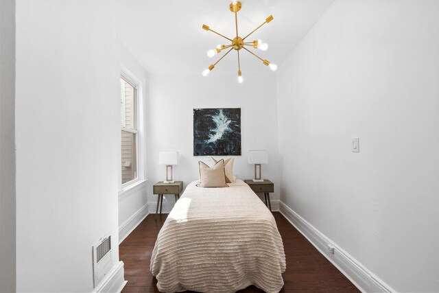48 Armstrong Ave, Jersey City, NJ 07305 - bedroom with a chandelier and dark wood-type flooring