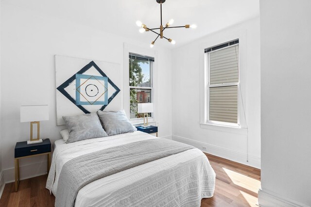 48 Armstrong Ave, Jersey City, NJ 07305 - bedroom featuring a chandelier and wood finished floors