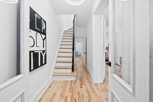 48 Armstrong Ave, Jersey City, NJ 07305 - foyer with light wood-style flooring and stairs