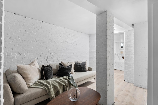 48 Armstrong Ave, Jersey City, NJ 07305 - living room with light wood-style flooring and brick wall