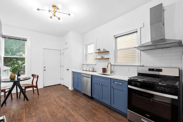 48 Armstrong Ave, Jersey City, NJ 07305 - kitchen with appliances with stainless steel finishes, wall chimney exhaust hood, blue cabinets, light countertops, and tasteful backsplash