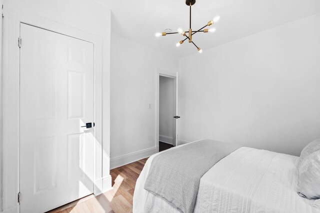 48 Armstrong Ave, Jersey City, NJ 07305 - bedroom featuring a chandelier and wood finished floors