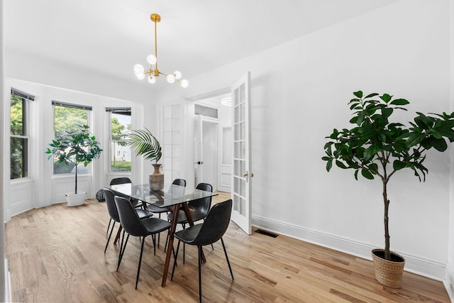 48 Armstrong Ave, Jersey City, NJ 07305 - dining area featuring light wood-type flooring and a chandelier