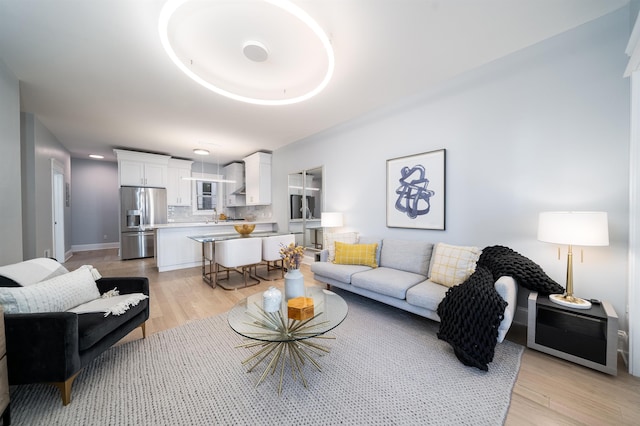 living room featuring light hardwood / wood-style flooring and sink