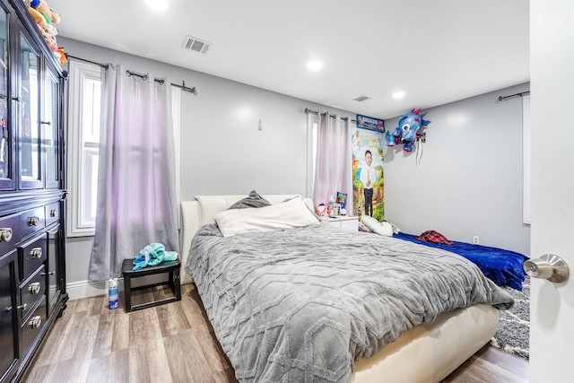 bedroom with recessed lighting, visible vents, and light wood finished floors