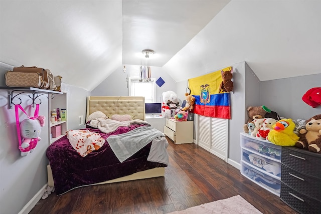 bedroom with vaulted ceiling, baseboards, and hardwood / wood-style floors