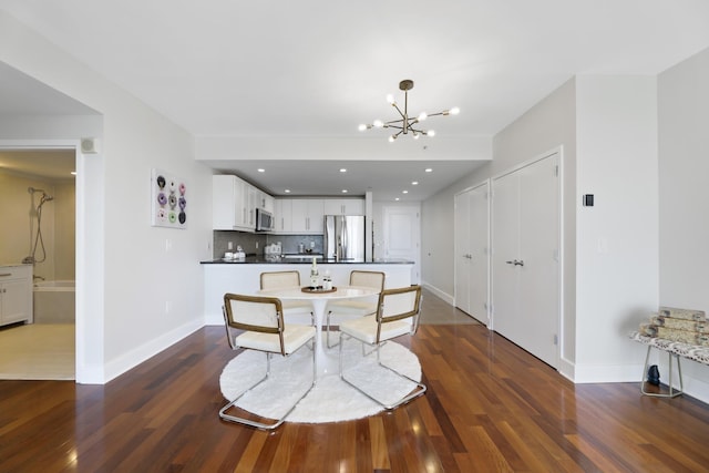 dining room featuring dark hardwood / wood-style flooring and a chandelier