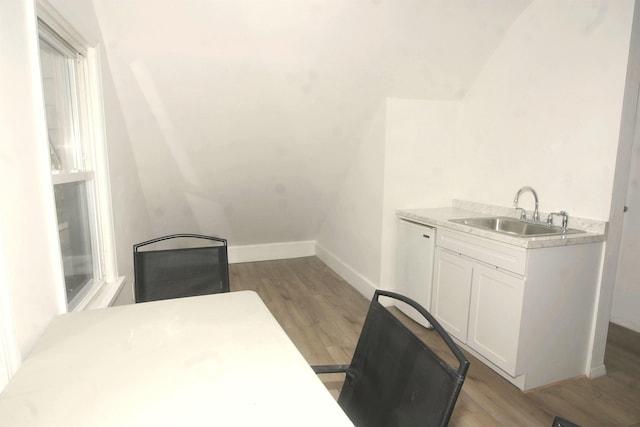 office with a sink, light wood-style floors, and baseboards