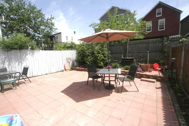 view of patio with outdoor dining space and a fenced backyard