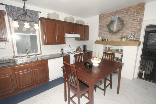 kitchen with white appliances, a sink, light marble finish flooring, dark countertops, and under cabinet range hood