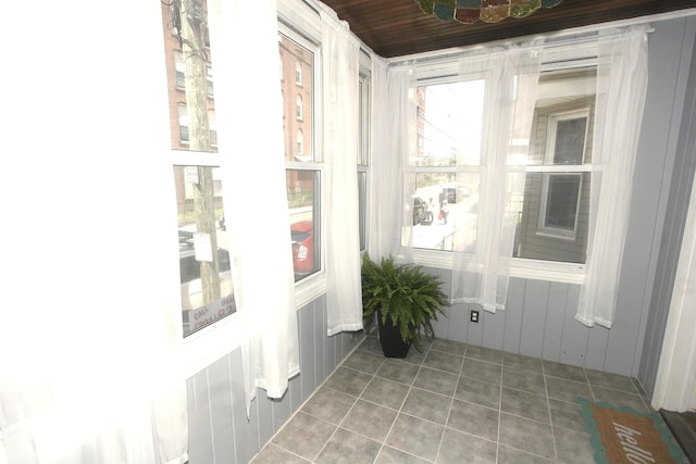 unfurnished sunroom featuring tile patterned flooring