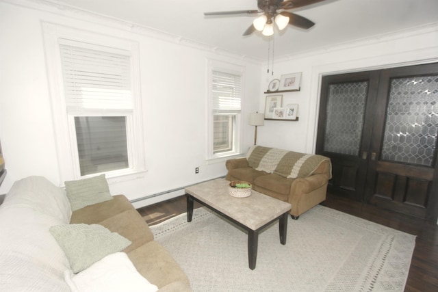living room featuring wood finished floors, a ceiling fan, crown molding, and a baseboard radiator