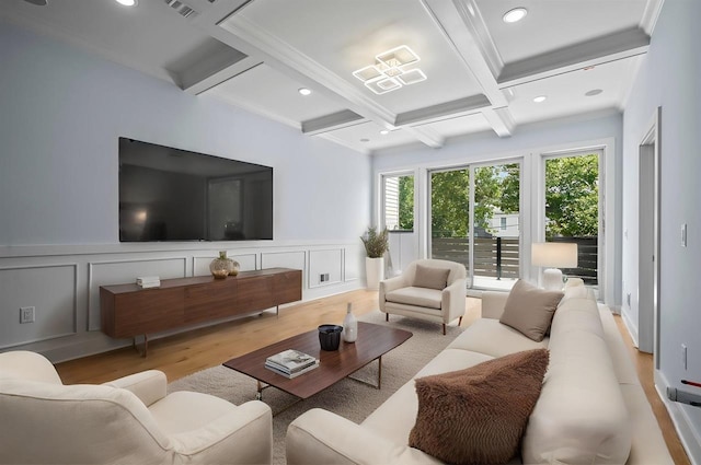 living room featuring ornamental molding, beamed ceiling, coffered ceiling, and light hardwood / wood-style flooring