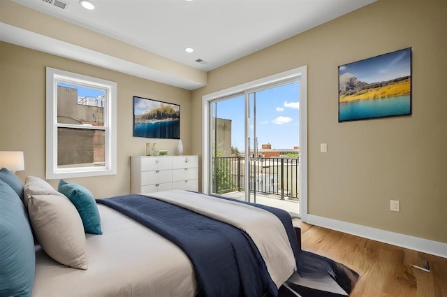 bedroom featuring hardwood / wood-style flooring and access to outside