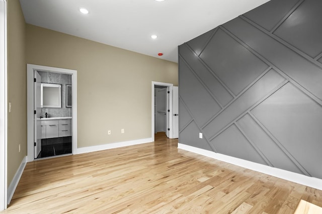 unfurnished room featuring light wood-type flooring and a fireplace