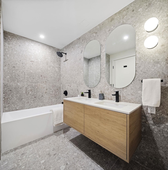 bathroom featuring bathing tub / shower combination, vanity, and tile walls