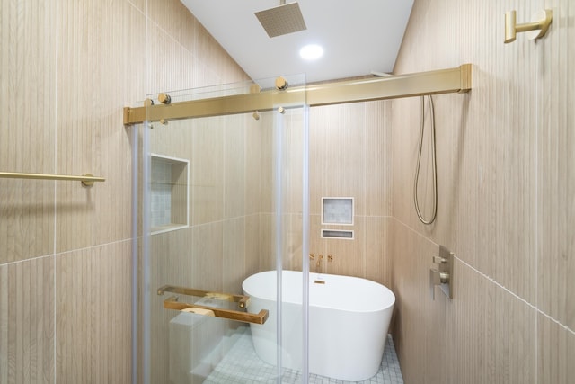 247 Harrison Ave Unit 2, Jersey City, NJ 07304 - bathroom featuring tiled shower, a freestanding tub, and tile walls