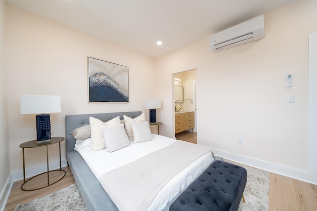 247 Harrison Ave Unit 2, Jersey City, NJ 07304 - bedroom with an AC wall unit, baseboards, wood finished floors, and recessed lighting